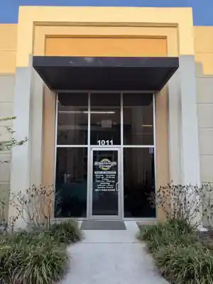 Commercial storefront entrance glazing with door, sidelites and transom under a canopy, from a Shore Tint & More window-film job